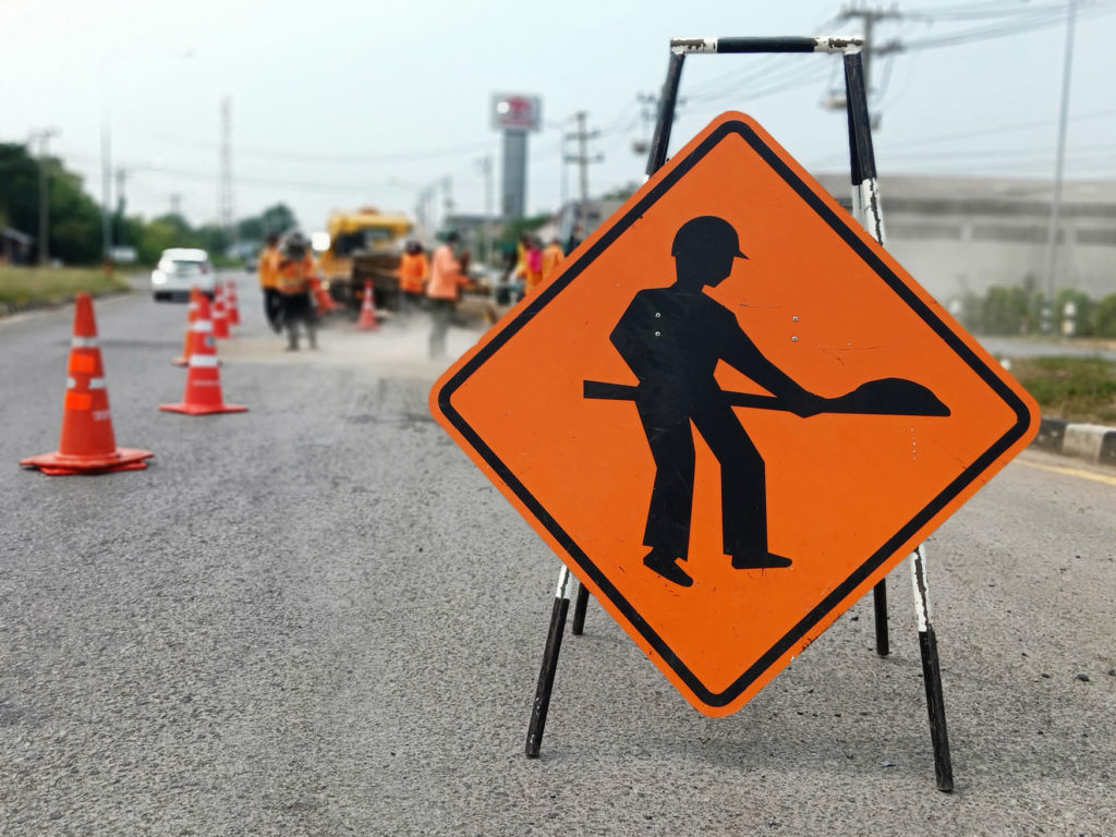 Construction warning ahead sign Photo by: suwichan / Adobe Stock